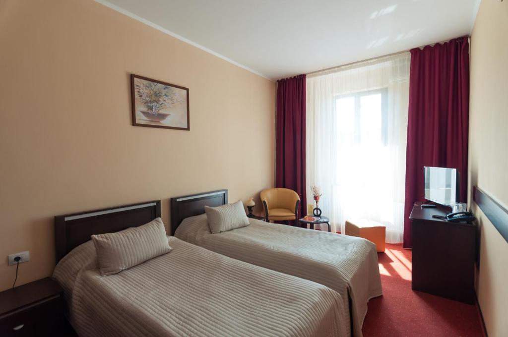 Postel nebo postele na pokoji v ubytování Hotel Magnus Galati
