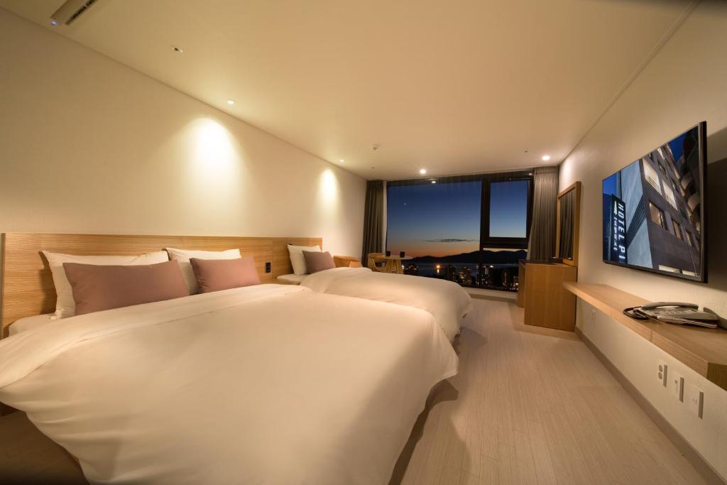 Postel nebo postele na pokoji v ubytování Pino Hotel