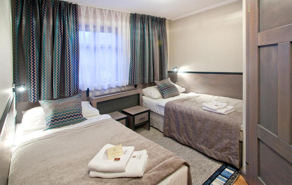Postel nebo postele na pokoji v ubytování Artus Resort