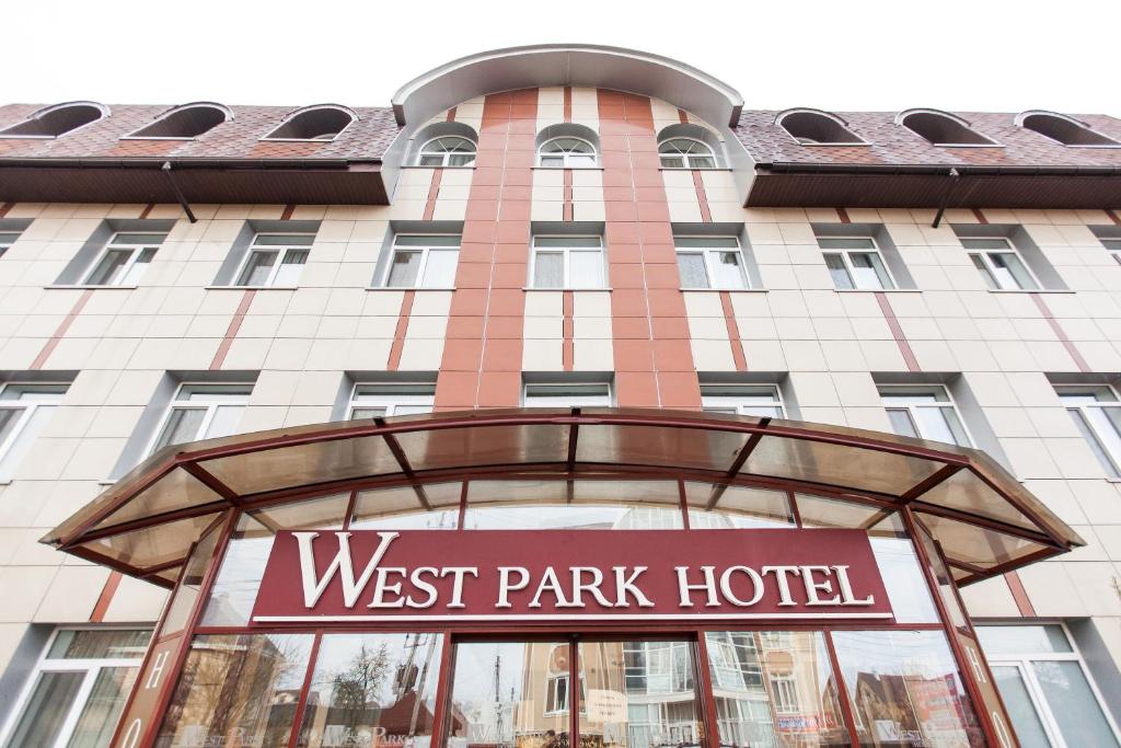 a sign for the west park hotel in front of a building at West Park Hotel in Kyiv