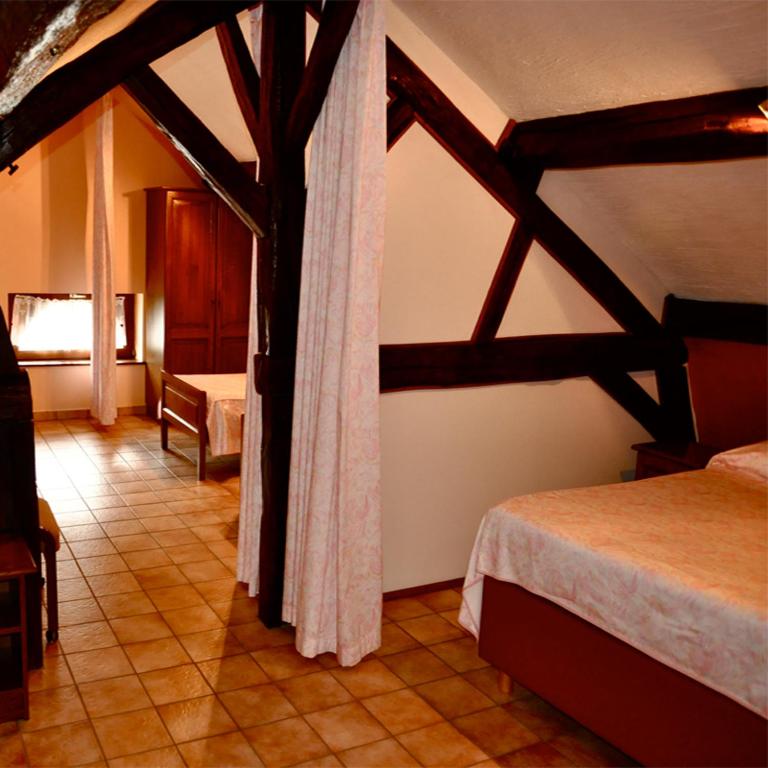Postel nebo postele na pokoji v ubytování Hotel IL Castellino