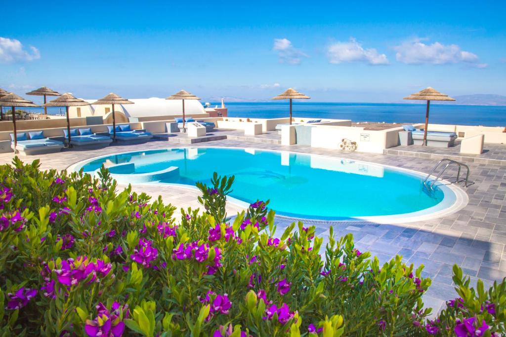 a swimming pool with a view of the ocean at Anemoessa Villa in Oia