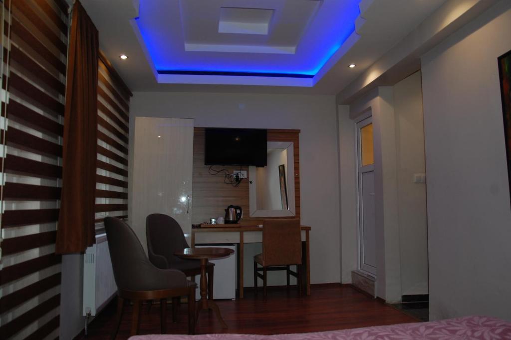 a living room with a blue light on the ceiling at Göznur Otel in Bandırma