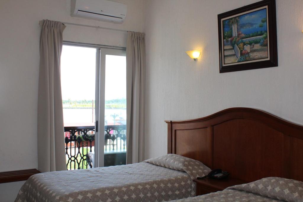 Postel nebo postele na pokoji v ubytování Hotel Posada Doña Lala