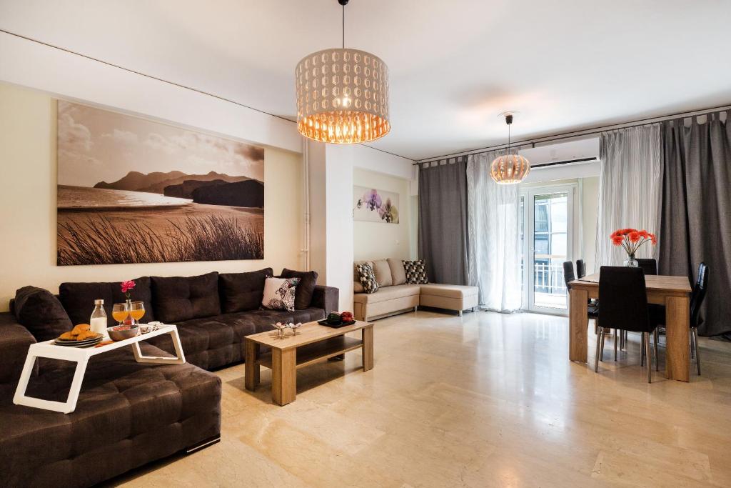 a living room with a couch and a table at Acropolis Boutique Suite in Athens