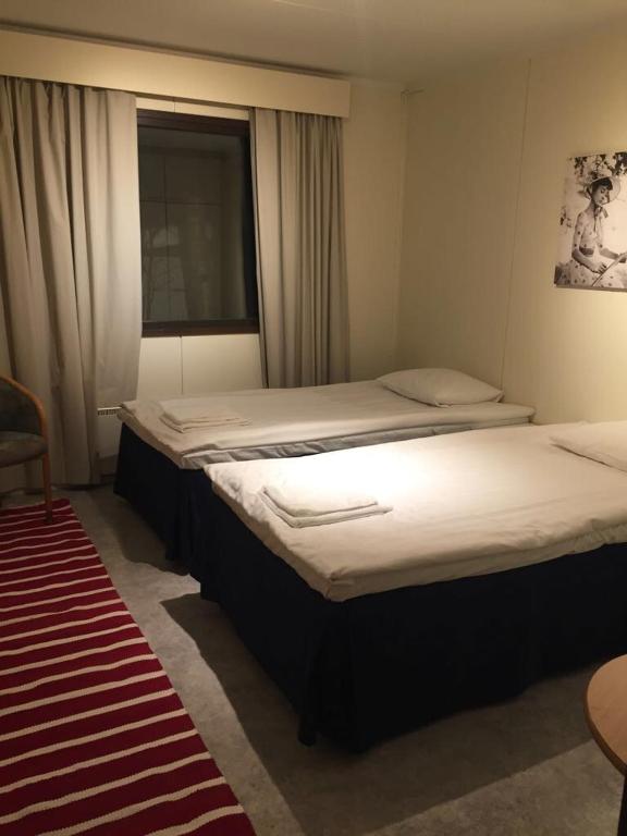 Postel nebo postele na pokoji v ubytování Mänty Holiday Apartments