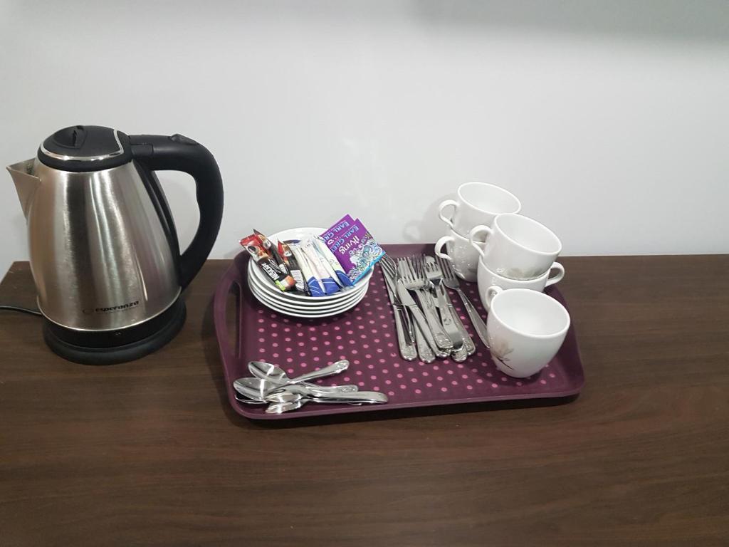 a tray with cups and utensils on a table at Noclegi u Andrzeja in Gdańsk