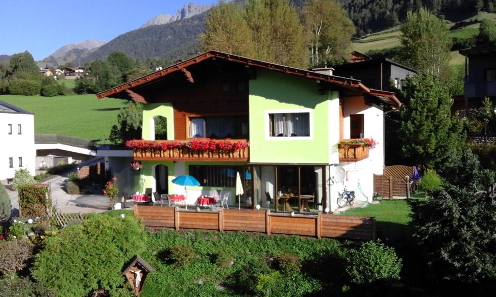 a house on a hill with flowers on the balcony at Gästehaus Kratzer in Virgen