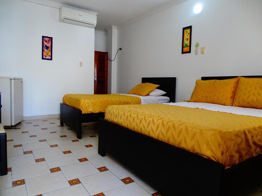 Postel nebo postele na pokoji v ubytování Alborada Hotel Melgar