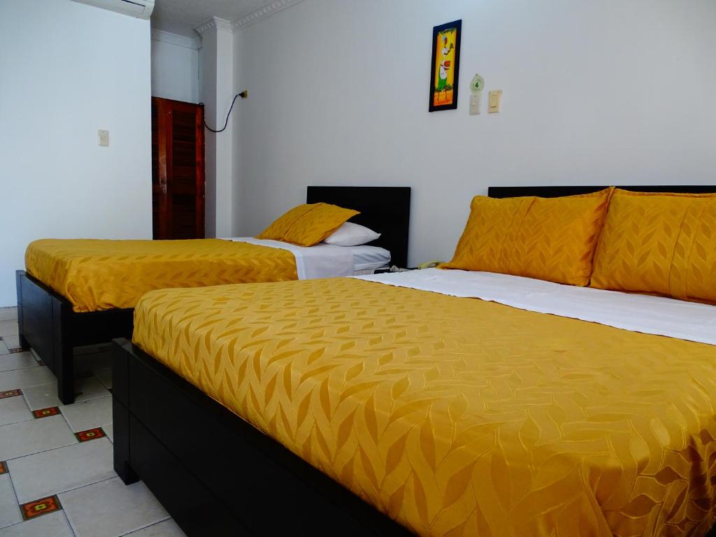 Postel nebo postele na pokoji v ubytování Alborada Hotel Melgar
