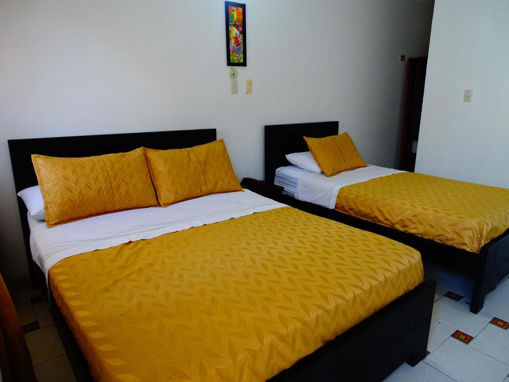 Postel nebo postele na pokoji v ubytování Alborada Hotel Melgar