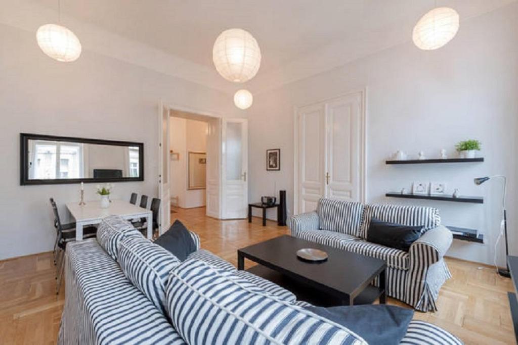 a living room with two couches and a table at Black & white apartment Budapest in Budapest
