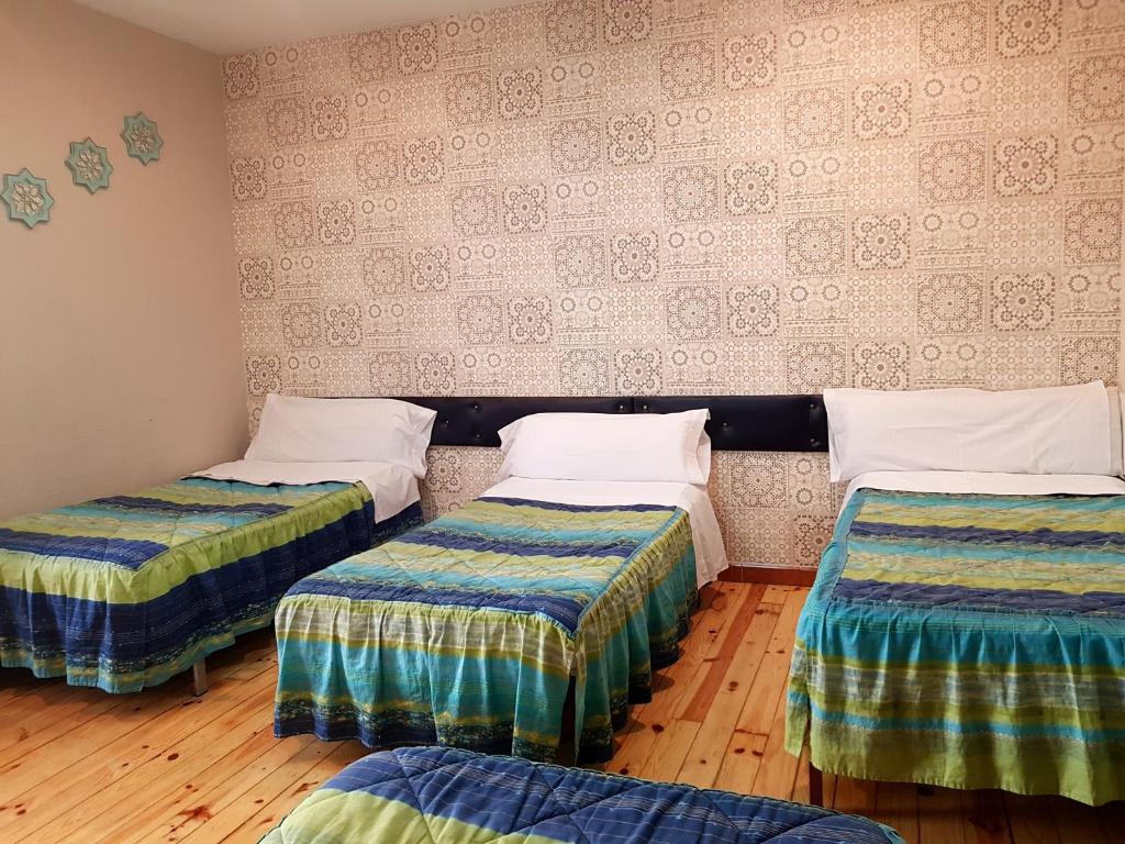 Posteľ alebo postele v izbe v ubytovaní Hostal Padre Isla 1