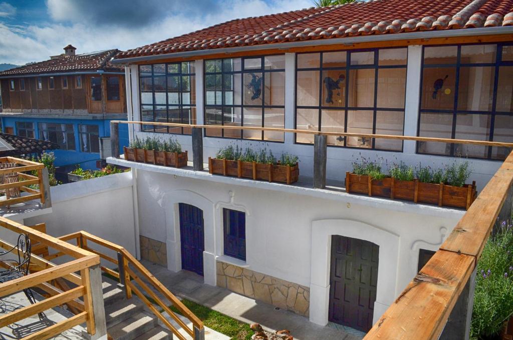 a building with potted plants on the side of it at La Tozi Hotel in San Cristóbal de Las Casas