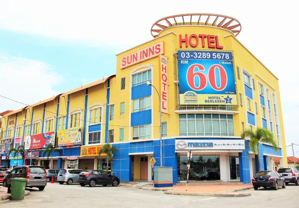 a large yellow building with a hotel sign on it at Sun Inns Hotel Kuala Selangor in Kuala Selangor