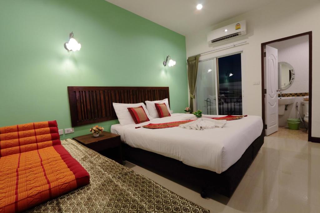 a hotel room with two beds and a mirror at BS Airport at Phuket in Nai Yang Beach