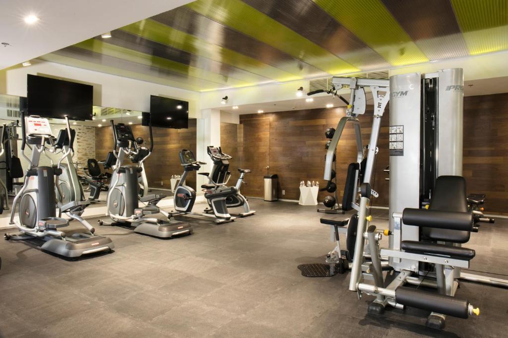 A bright, fully equipped hotel gym with cardio and strength-training machines.