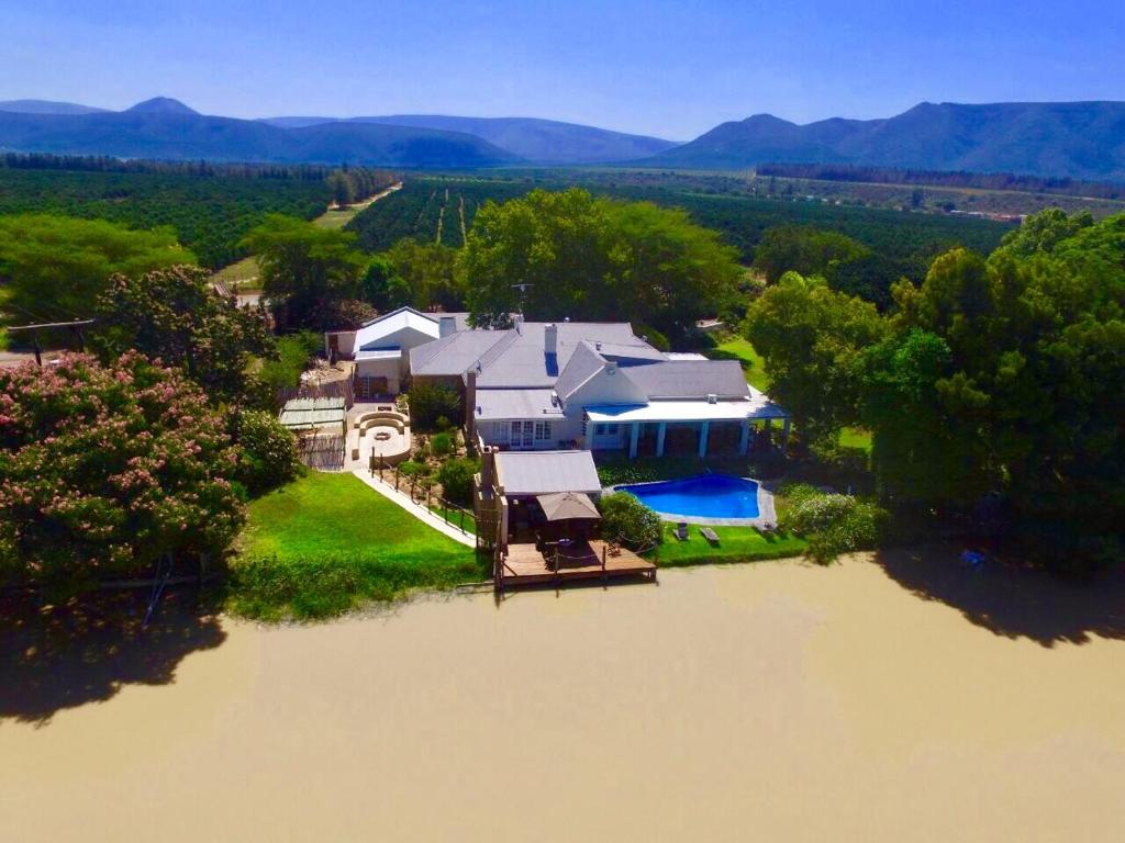 an aerial view of a house in the middle of a river at Broadlands Country House in Kirkwood