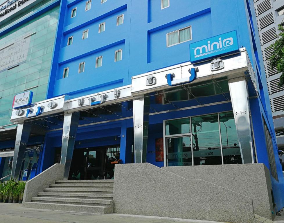 a blue building with stairs in front of it at The Mini R Ratchada in Bangkok