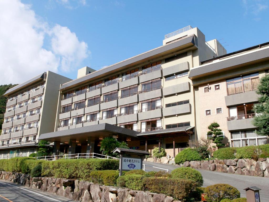 a large building with a road in front of it at Yumoto Kanko Hotel Saikyo in Nagato