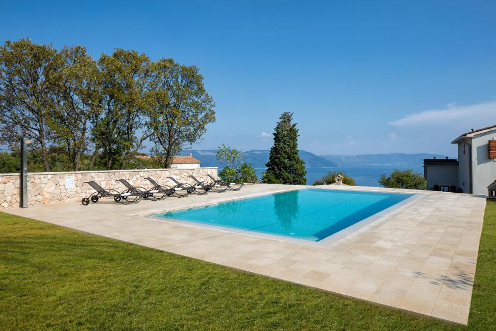 a swimming pool in the backyard of a house at Villa Primela**** in Labin