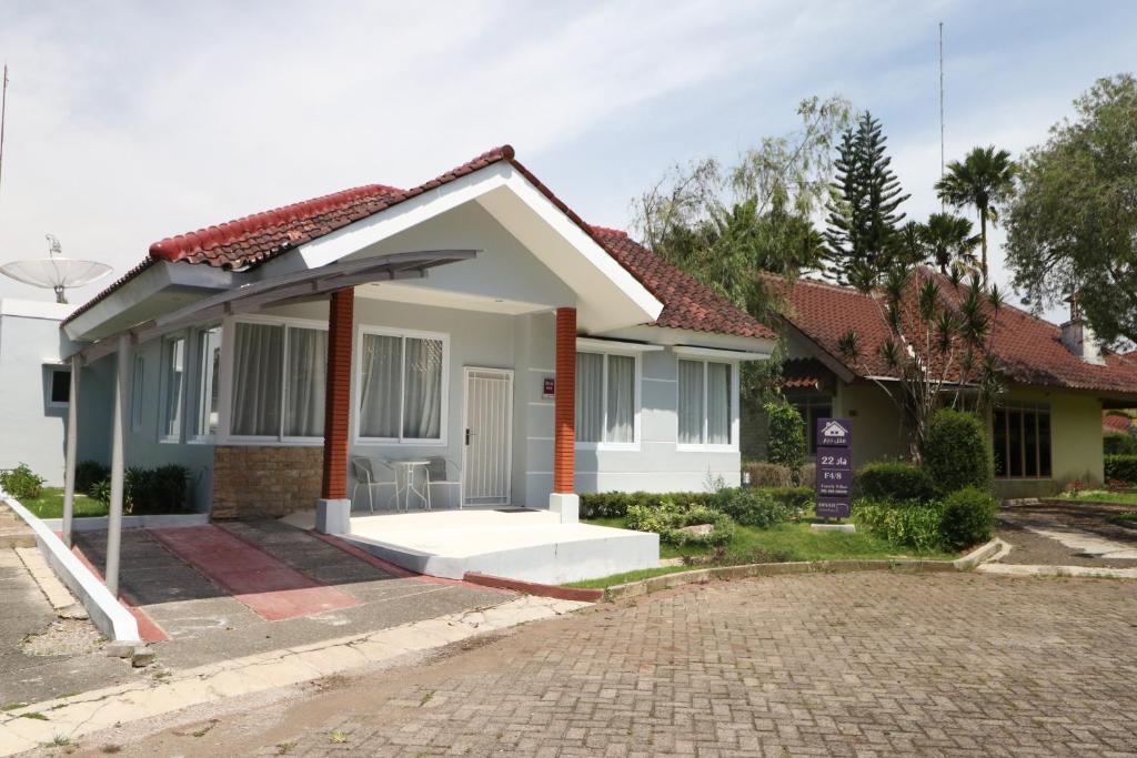 a small house with a driveway in front of it at Diyar Villas Puncak F4/8 in Puncak