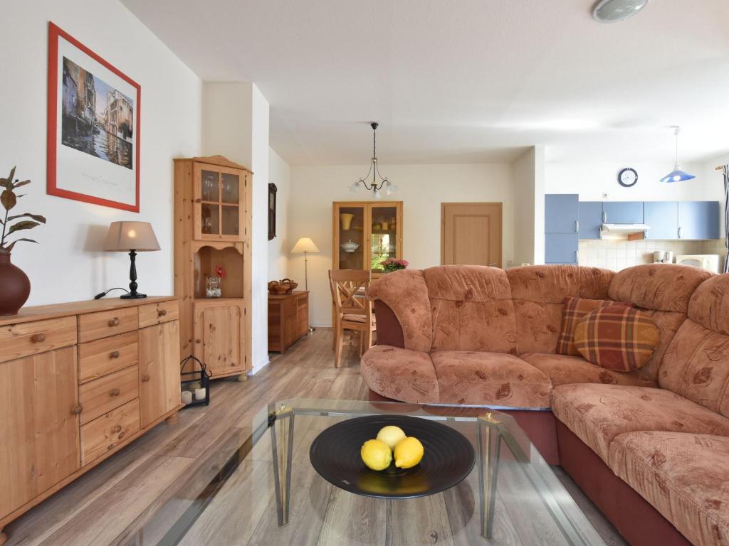 a living room with a couch and a table at Comfortable Apartment in Kuhlungsborn Near Sea in Kühlungsborn