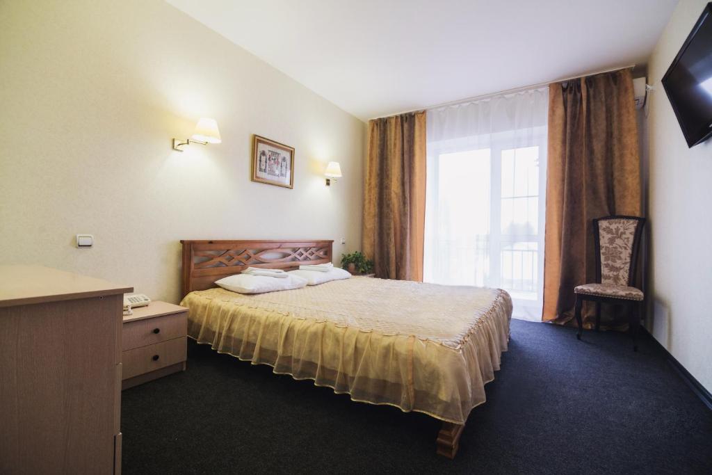 Кровать или кровати в номере Гостиница Святогор с русской баней