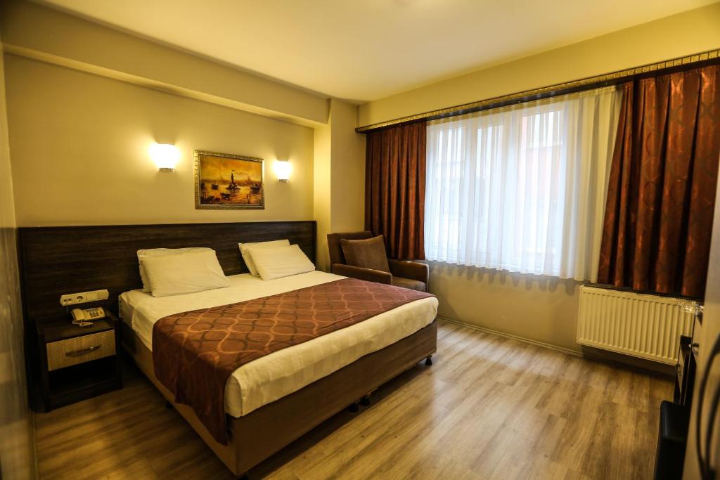 a hotel room with a bed and a window at Canakkale Bogaz Hotel in Çanakkale