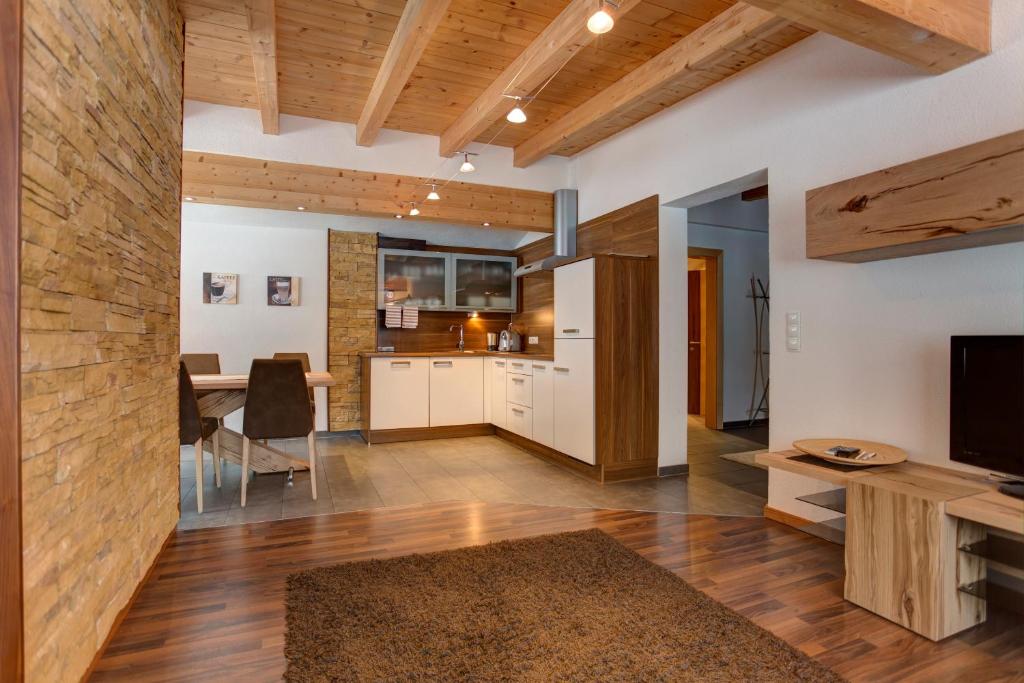 a living room with a kitchen and a dining room at Haus Mattle in Pettneu am Arlberg