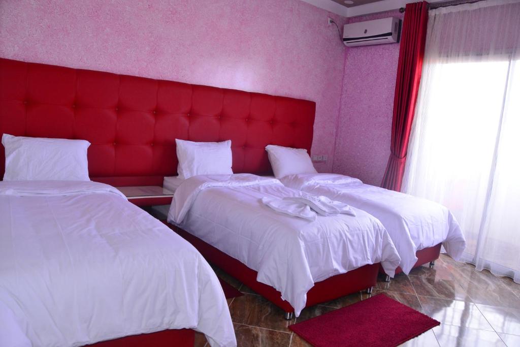 Una cama o camas en una habitación de Hôtel Hadaik Ain Asserdoune