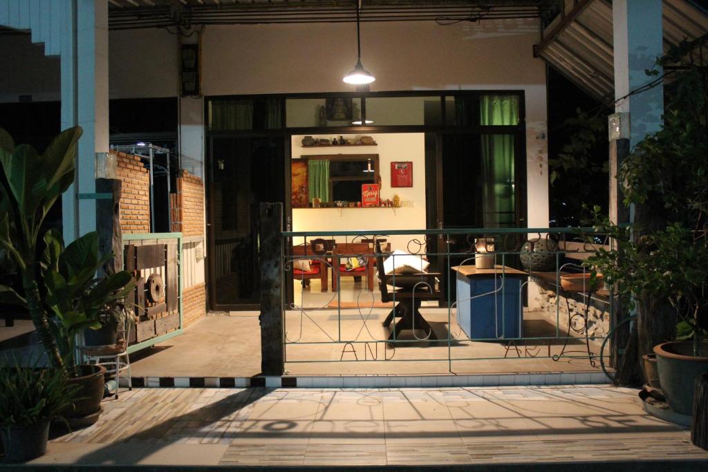 an open door to a patio with a table and chairs at Rec Art (House of recycle+Art) in Ko Samed