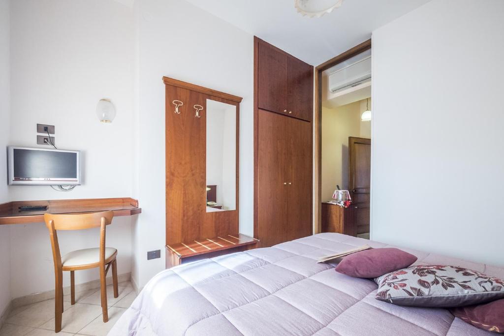 Postel nebo postele na pokoji v ubytování Grifone Hotel