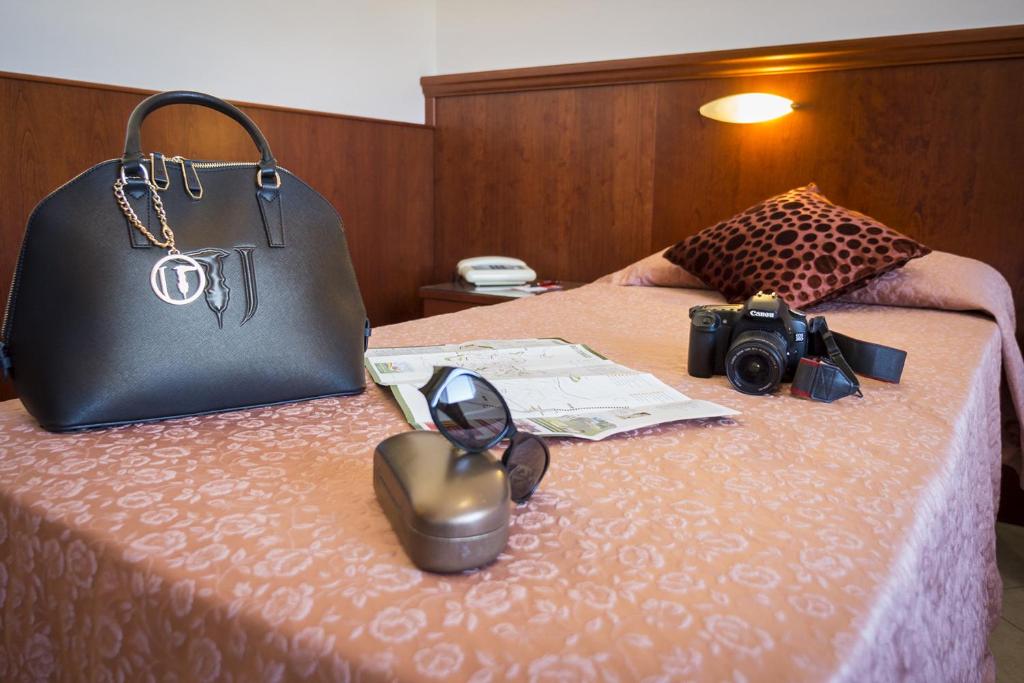 Postel nebo postele na pokoji v ubytování Grifone Hotel