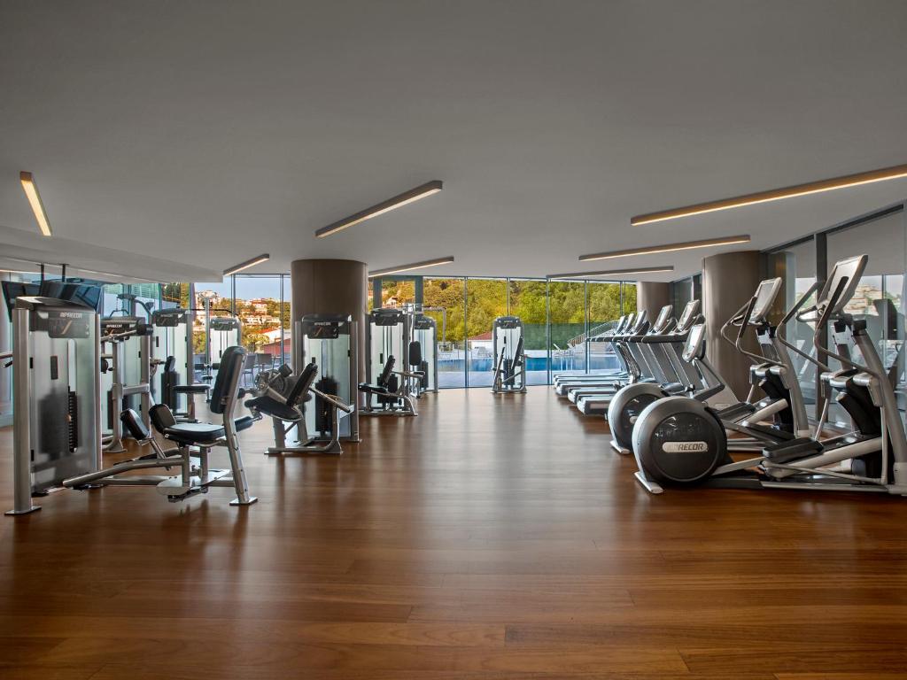a gym with a lot of treadmills and machines at The Grand Tarabya Managed by Accor in Istanbul