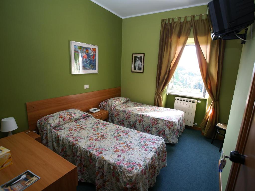 Postel nebo postele na pokoji v ubytování Hotel Sutrium