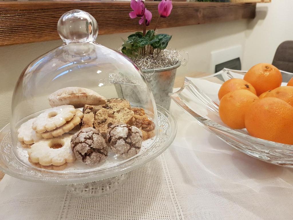 a glass bowl of donuts and cookies on a table at Romantic Apartments Sweet Baci in Maribor