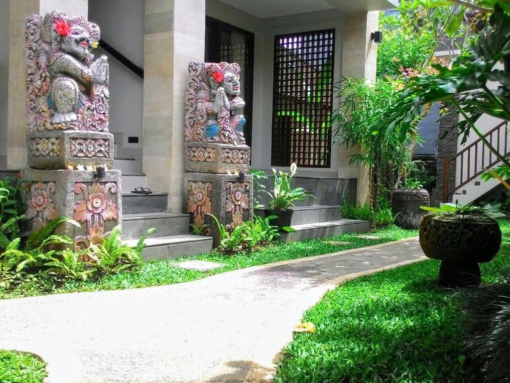 a house with a garden with colorful art on it at ThreeWin Homestay in Ubud