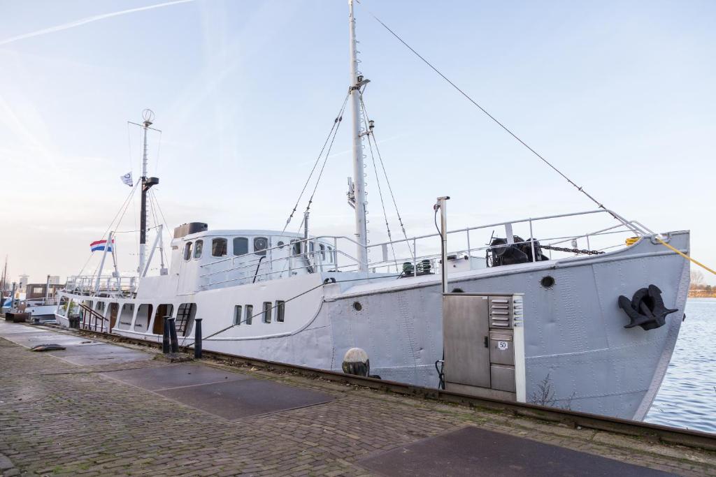 a large white boat is docked in the water at M/S Svalbard B&B in Amsterdam
