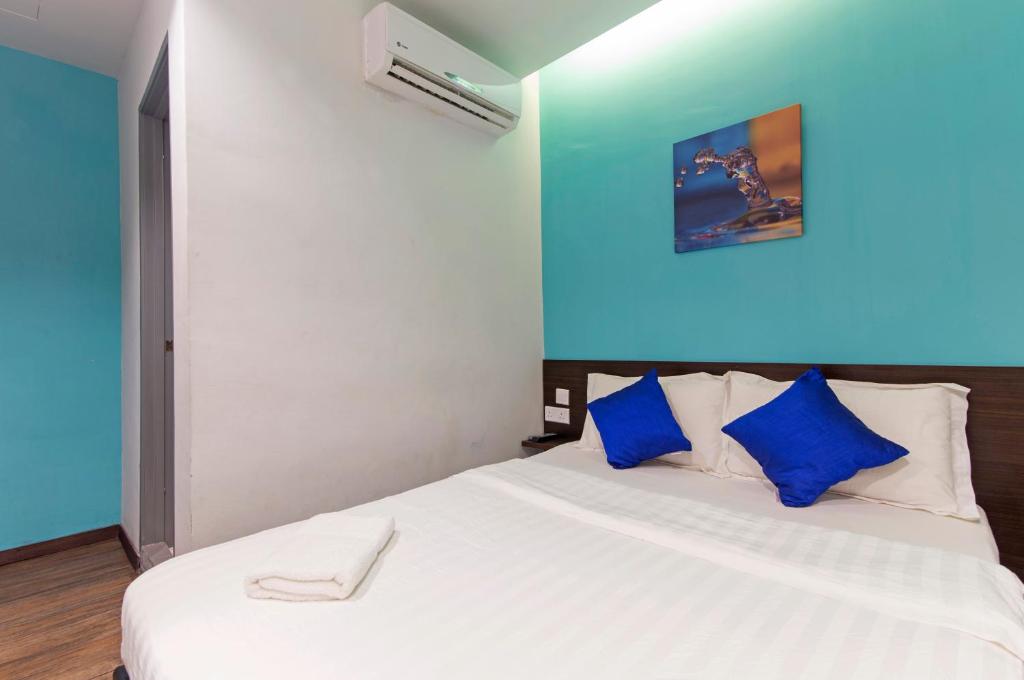 Postel nebo postele na pokoji v ubytování Clover Hotel Ipoh