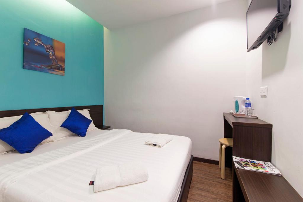 Postel nebo postele na pokoji v ubytování Clover Hotel Ipoh