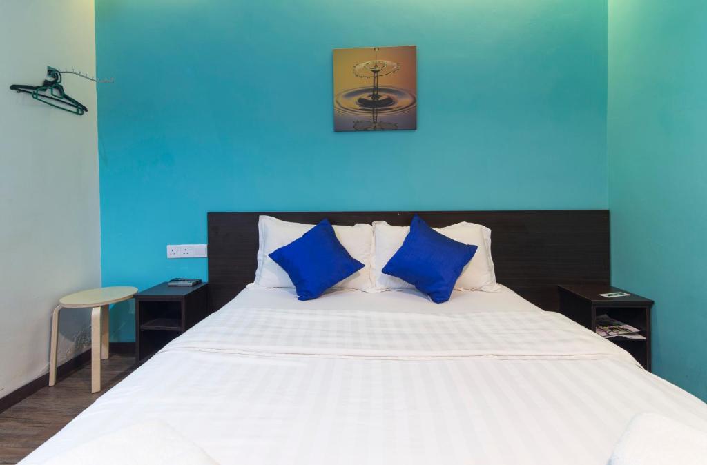 Postel nebo postele na pokoji v ubytování Clover Hotel Ipoh