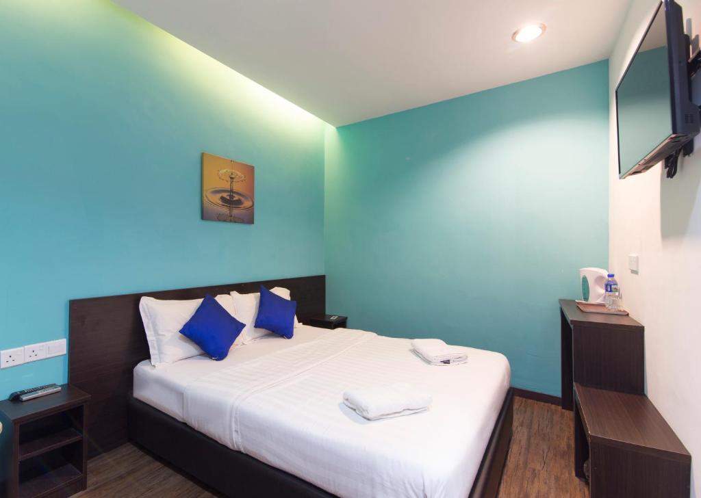Postel nebo postele na pokoji v ubytování Clover Hotel Ipoh