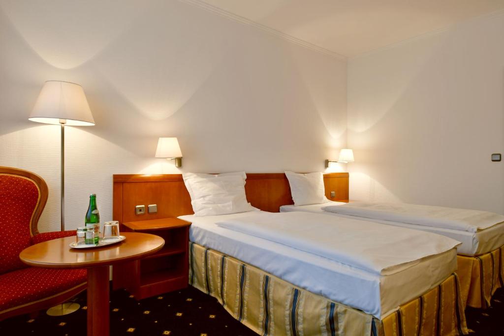 Postel nebo postele na pokoji v ubytování Hotel Coronet
