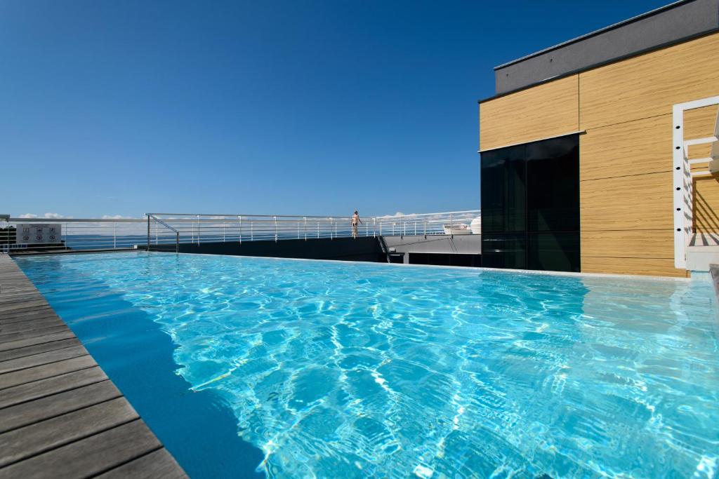 a swimming pool on the roof of a building at Hotel Split in Podstrana
