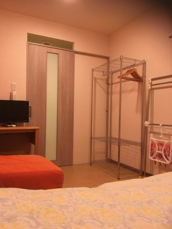 Postel nebo postele na pokoji v ubytování Hotel Asahi Grandeur Fuchu