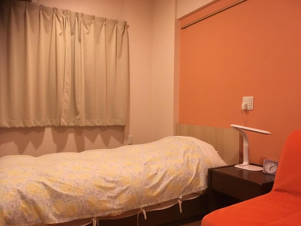 Postel nebo postele na pokoji v ubytování Hotel Asahi Grandeur Fuchu