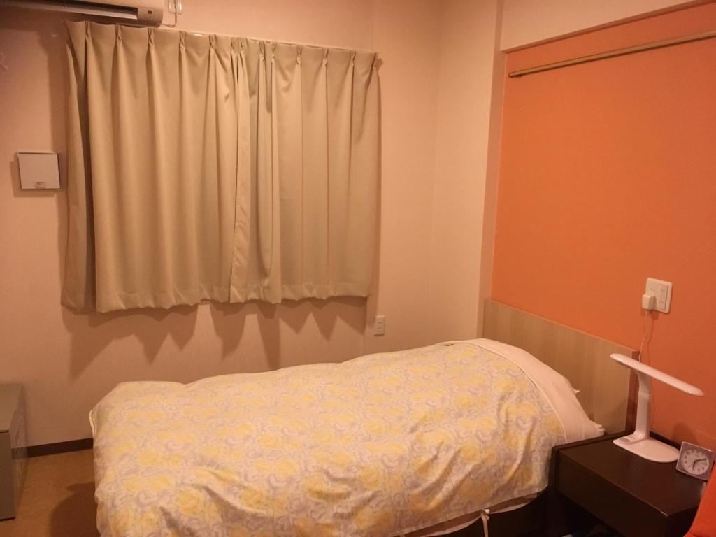 Postel nebo postele na pokoji v ubytování Hotel Asahi Grandeur Fuchu