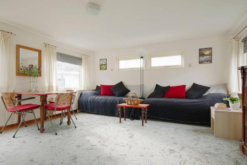 a living room with a couch and a table at Studio on a houseboat, near city centre! in Amsterdam