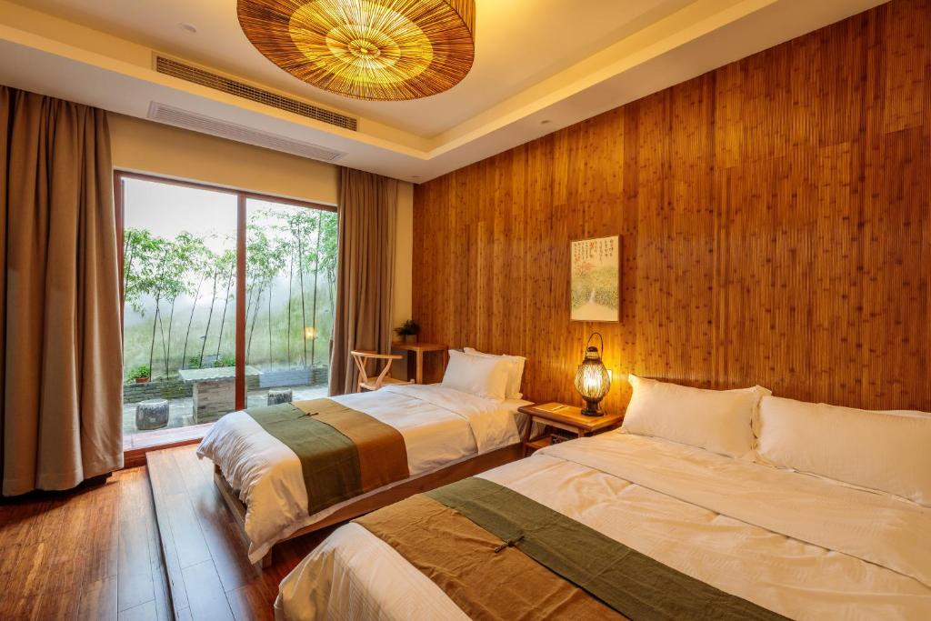 Postel nebo postele na pokoji v ubytování Dan’s Sea Guest House Hangzhou